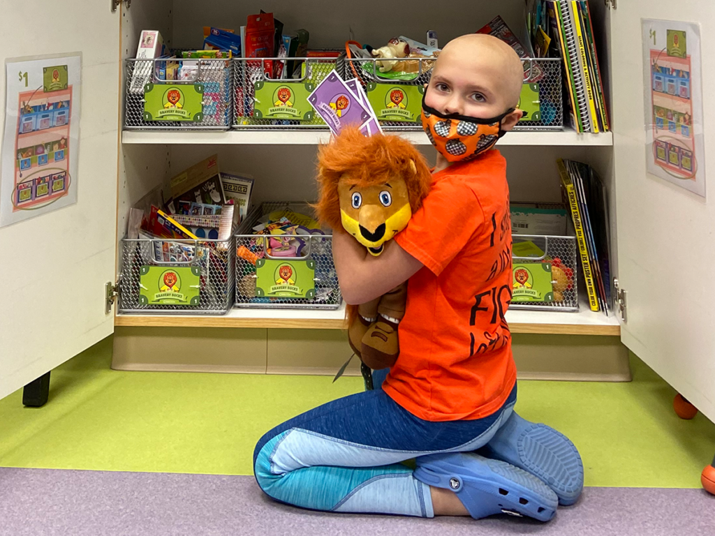 photo of child and louie the lionheart in the courage store