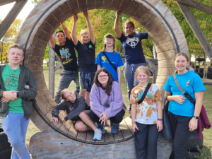 teens in a big wooden wheel at teen camp